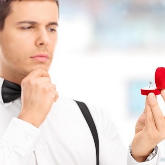 man staring at wedding ring